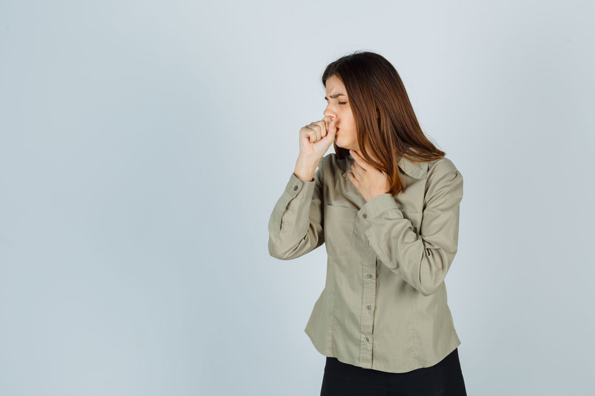 young lady shirt skirt suffering from cough looking sick front view